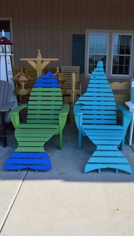 outdoor chairs shaped like a green and blue fish and a blue dolphin